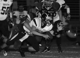 Placer High Senior Anthony Hess tackles a South Anchorage team member