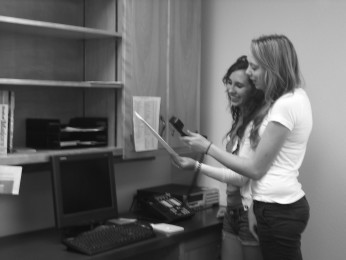 Leadership students Mandy Matthews and Rachel Roskelly utilize the new intercom system during second period. 