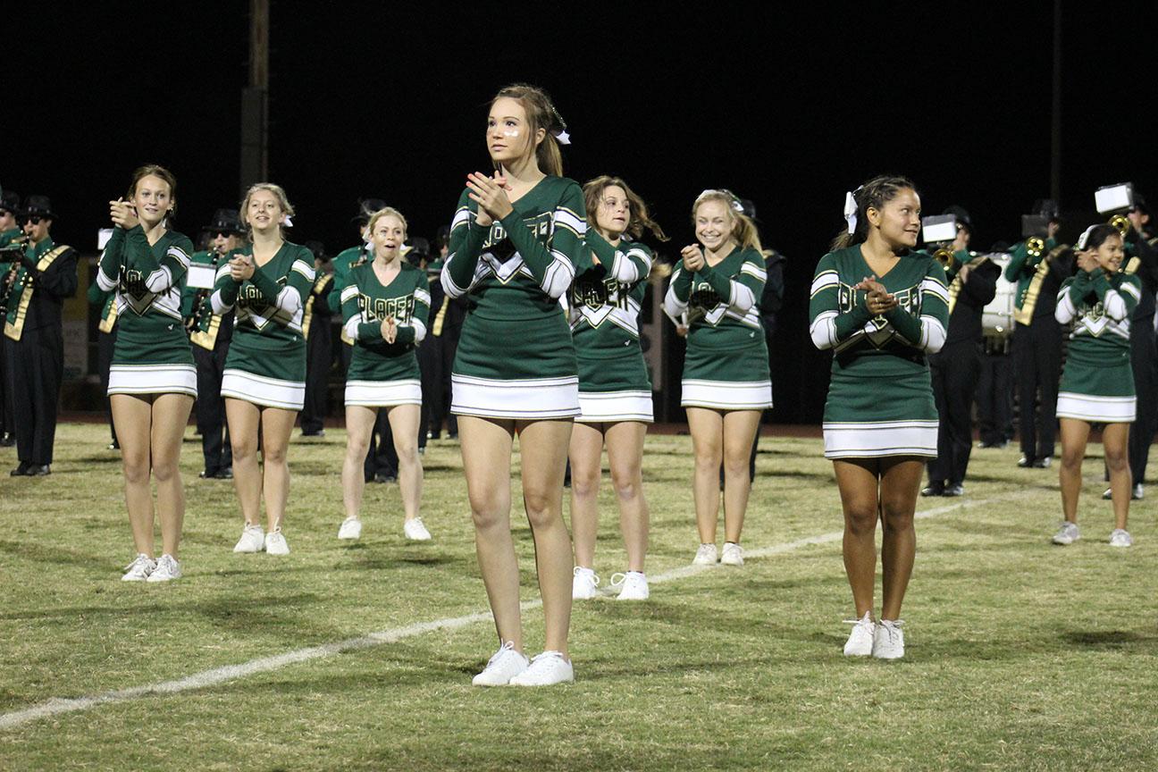 This year’s cheerleading squad performs at the Homecoming game. Some students wonder why they limit their appearances to just football and basketball.