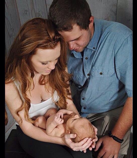 Abigail Strong and fiance Landon Tucker holding Bentley 