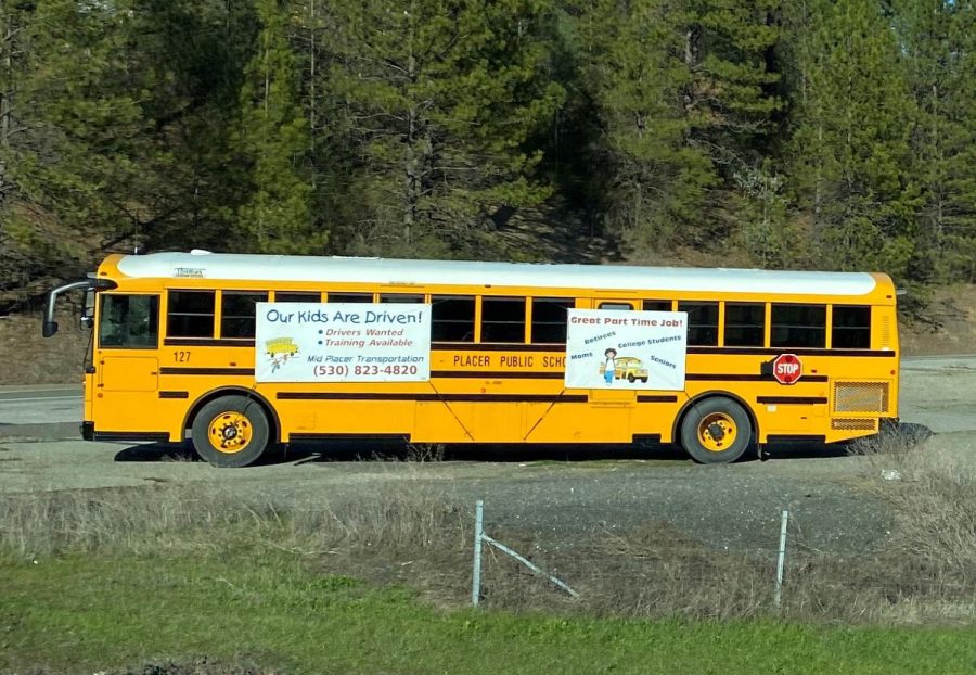A bus parked on the corner of Bell Road and Bowman Road advertise a need for local bus drivers. 