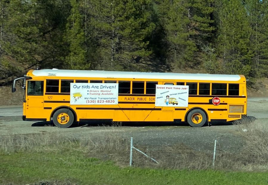 A+bus+parked+on+the+corner+of+Bell+Road+and+Bowman+Road+advertise+a+need+for+local+bus+drivers.+