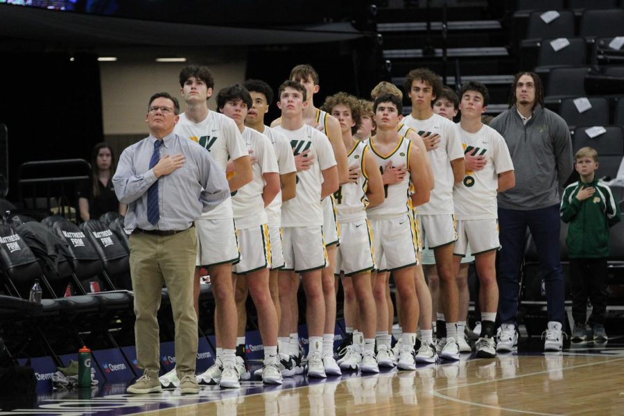 Coach+Mark+Lee+and+the+Placer+varsity+team+stand+for+the+National+Anthem+prior+to+the+tip+off+and+the+Golden+1+Center.+